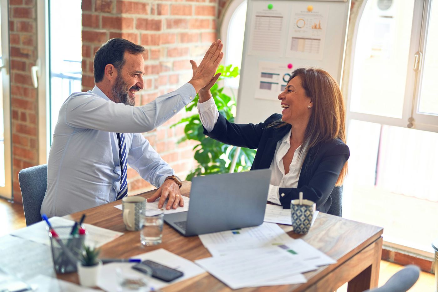 Two advisors in discussion during a confidential client meeting