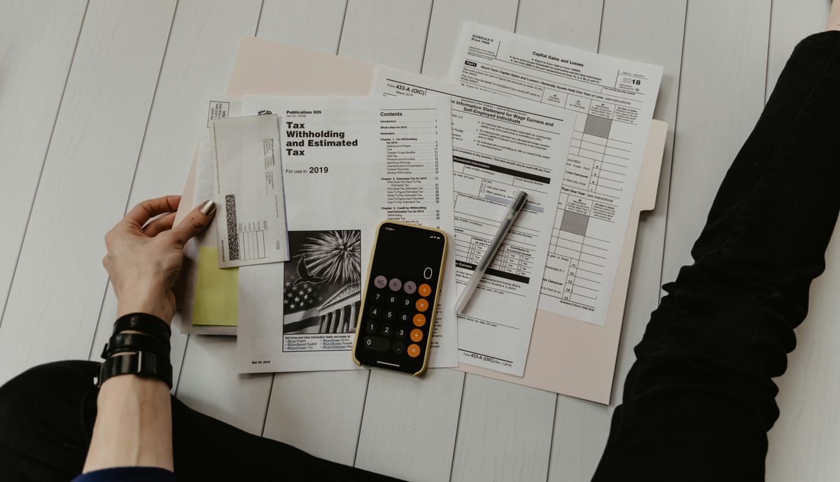 Documentary trade-finance paperwork with calculator prepared for review